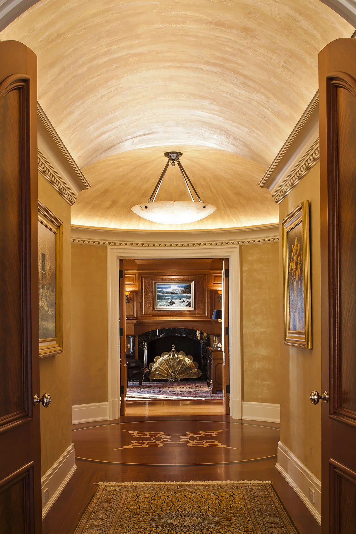 Lit arched hallway with view of home office