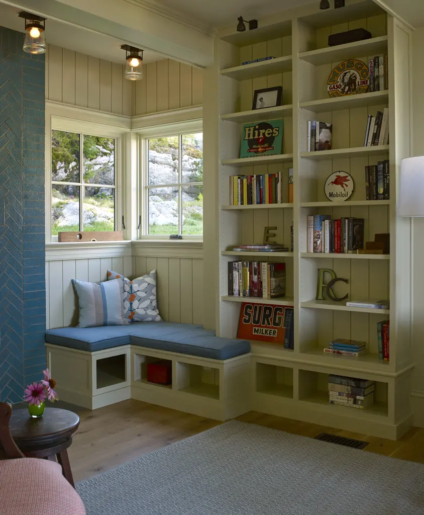 Reading nook with built-in bookshelves and views of nature at Capitol Island