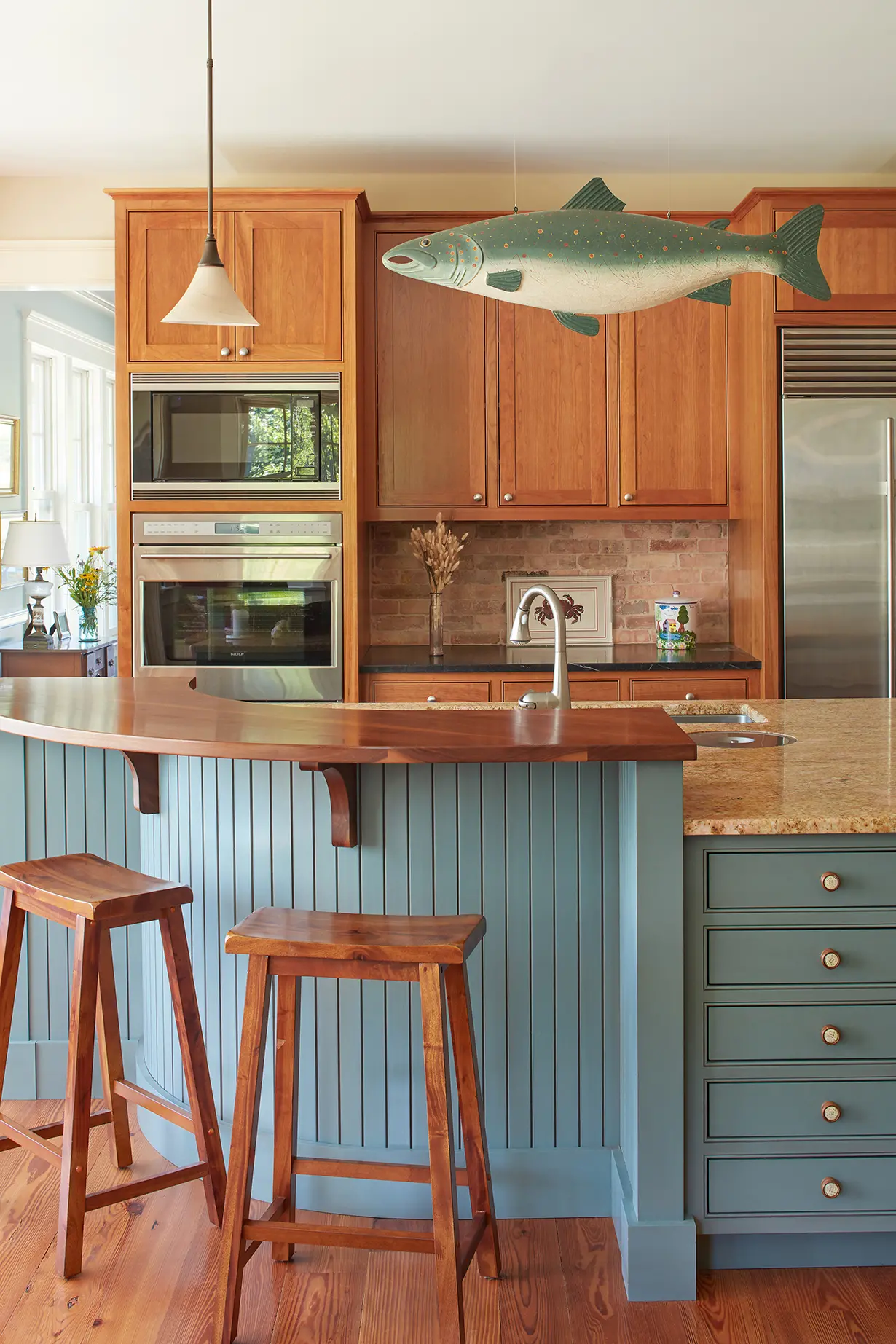 Rounded island seating with fish decor in the kitchen at Highfields