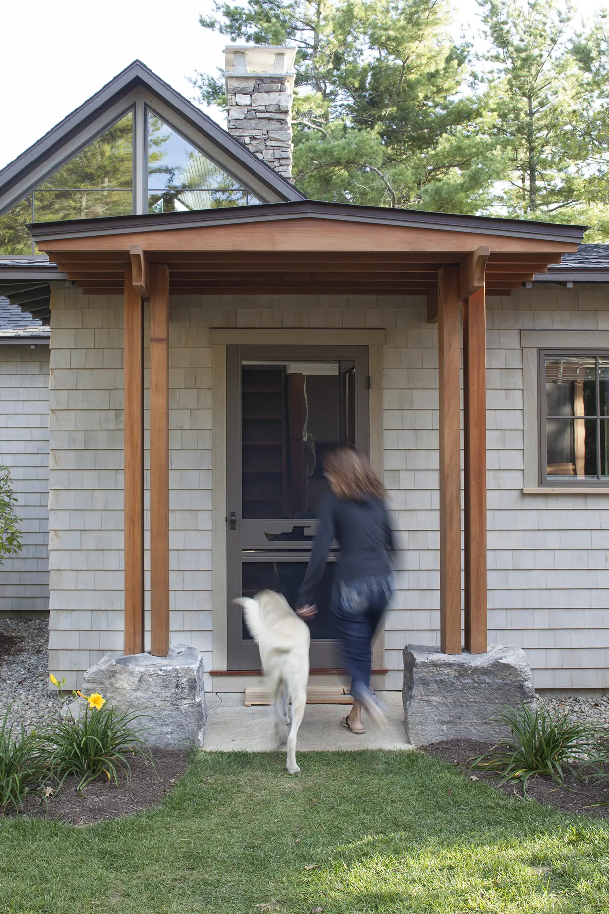 The entry with stone and wooden columns at the Cross Point Cottages