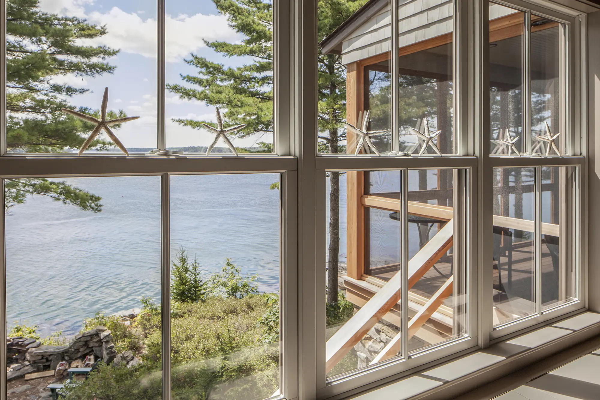 Expansive windows offering panoramic views at the Cross Point Cottages