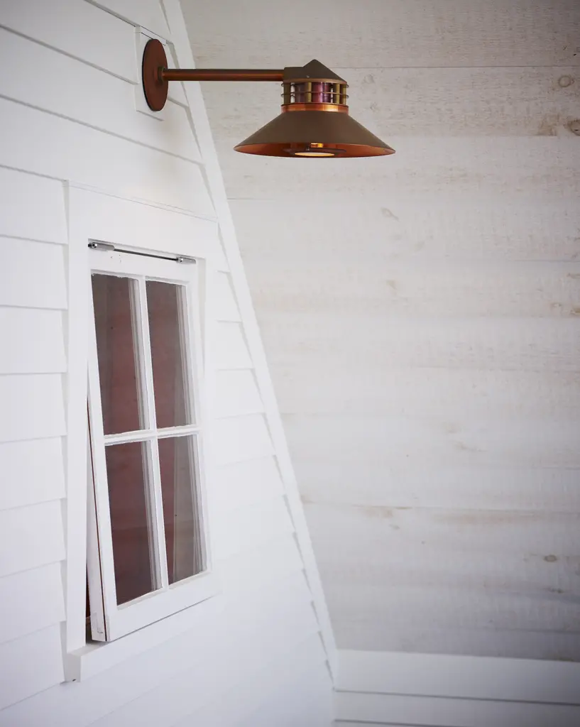 Brass light fixture and wood paneling