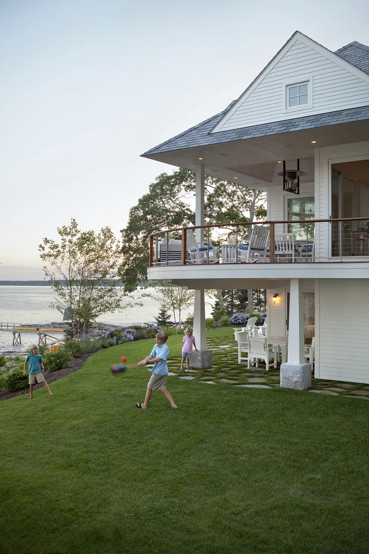 A view of the patio under the deck with the expansive play area.