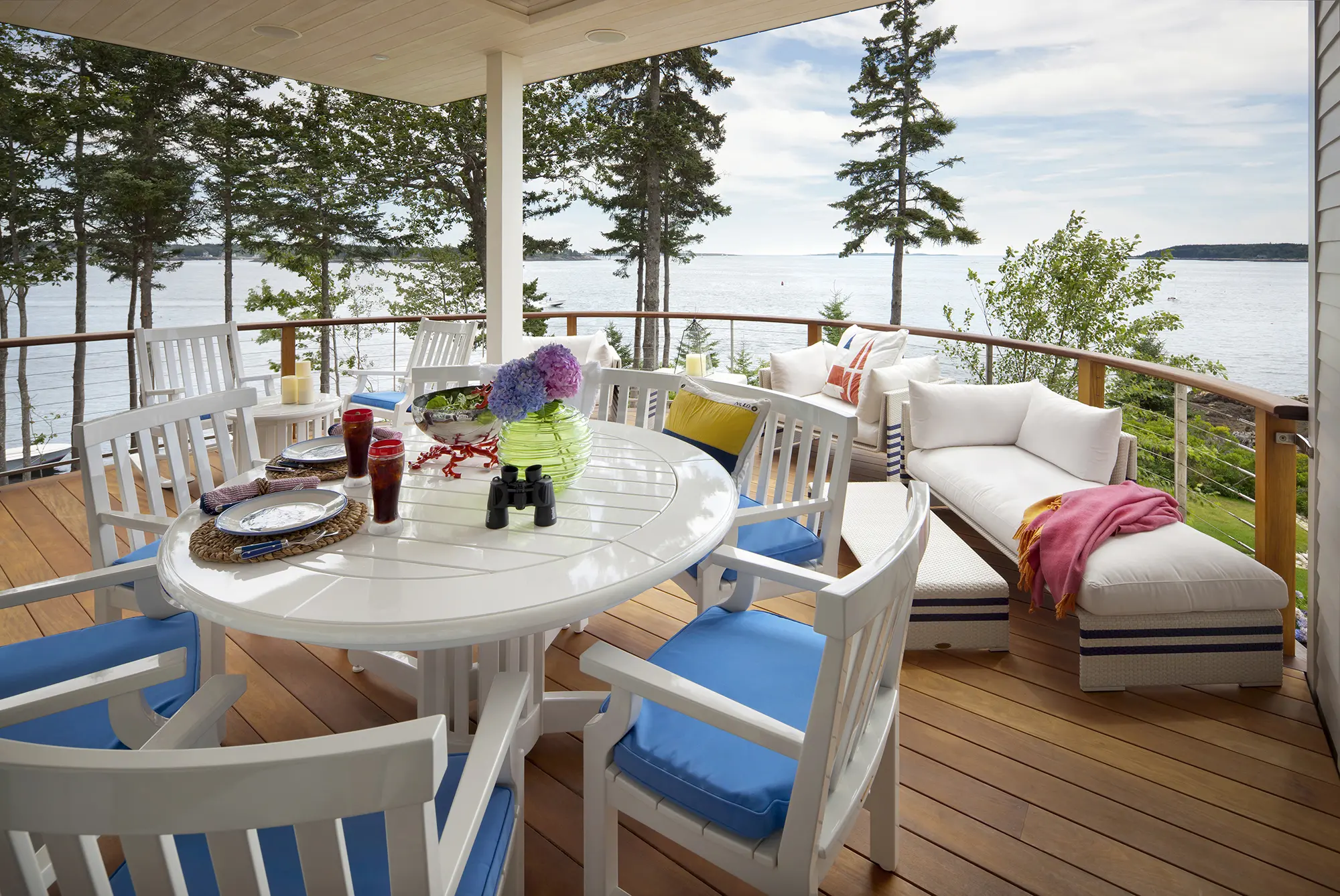 Covered deck with plenty of sitting space and coastal views