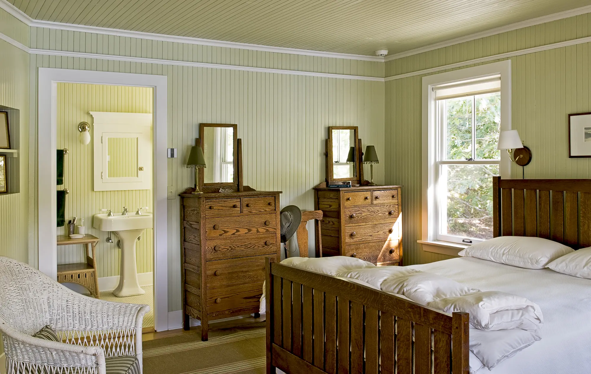 Matching, dark wood dressers and wood paneled walls and ceilings