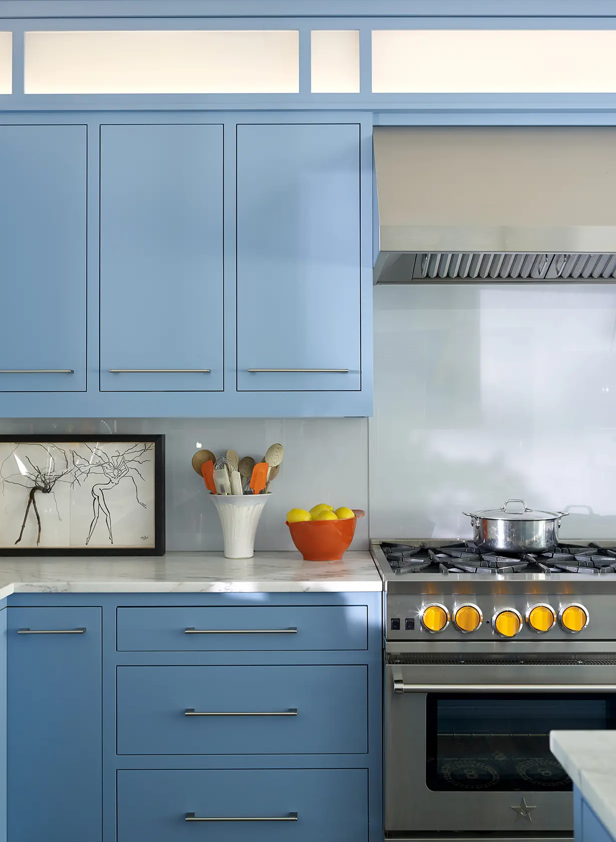 Blue cabinets with marble countertops in the bright kitchen at Summer Haven