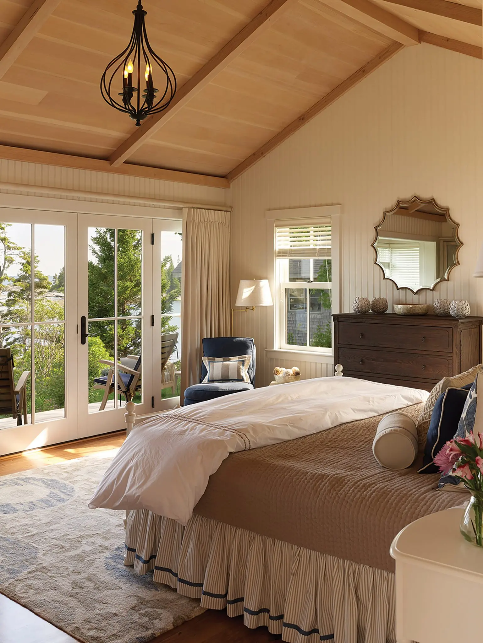 Paneled bedroom with french doors to porch