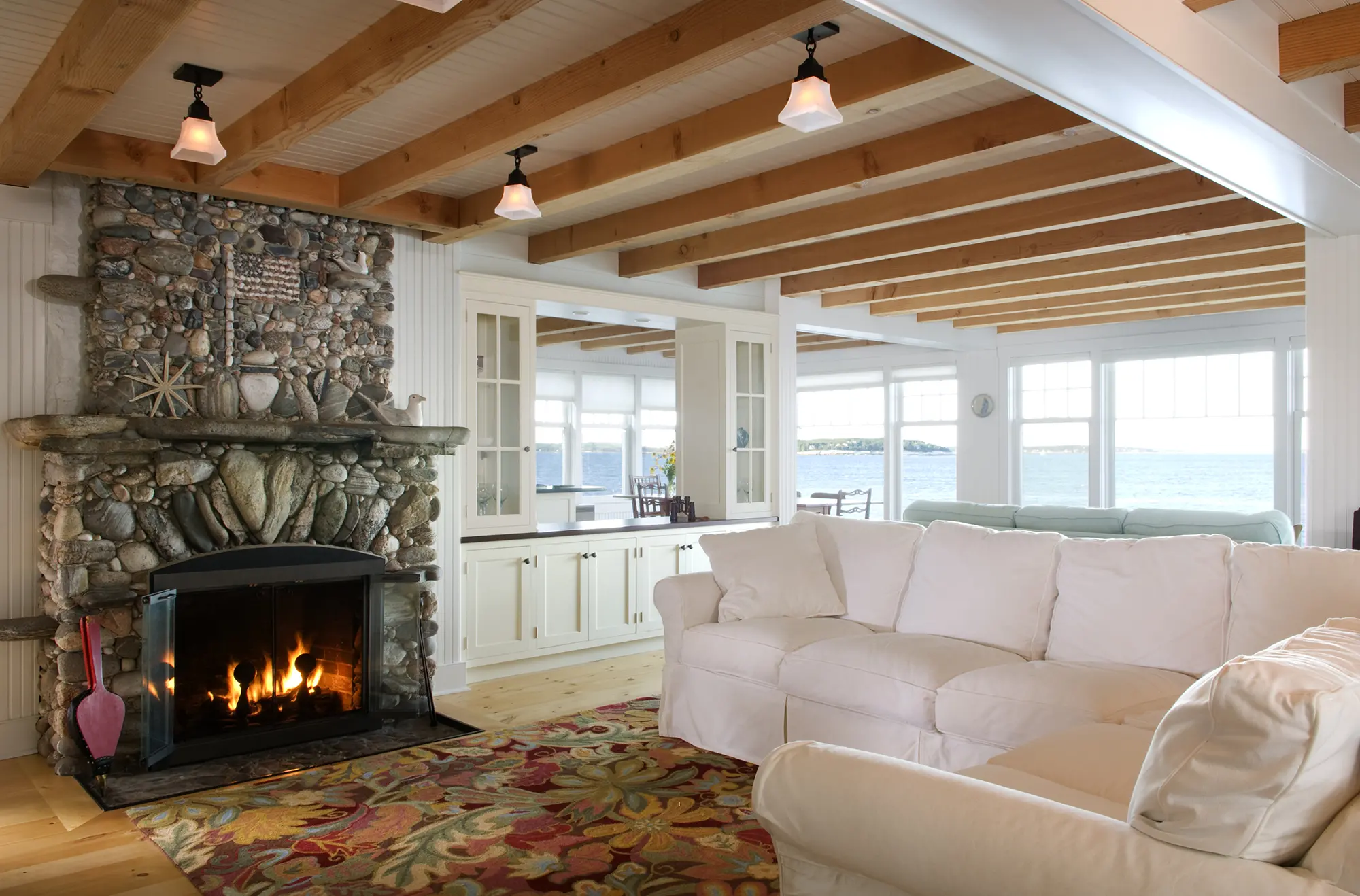 Sun filled living space with stone fire place and water views at Bayberry
