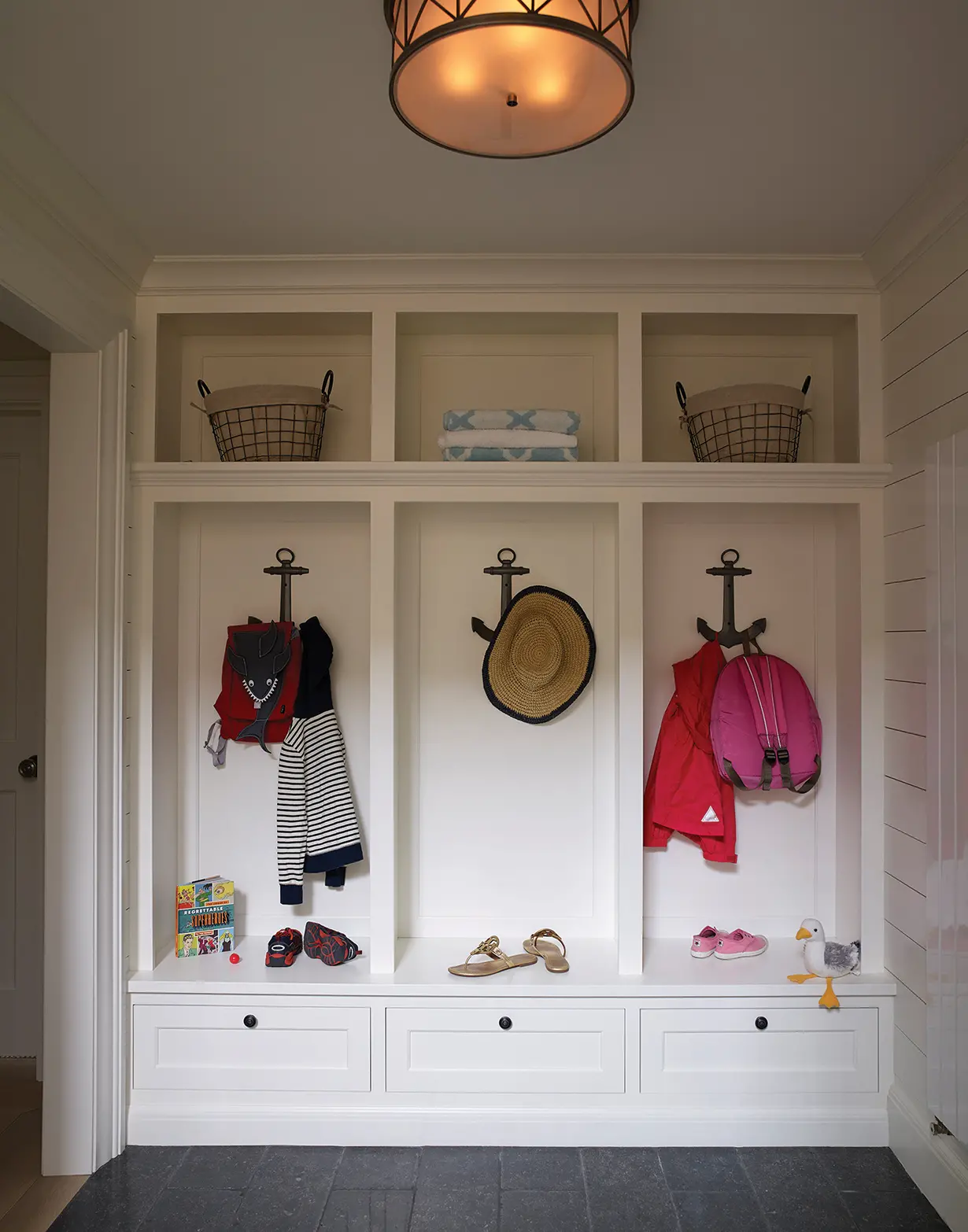 Nautical inspired hooks and custom cubbies in mudroom