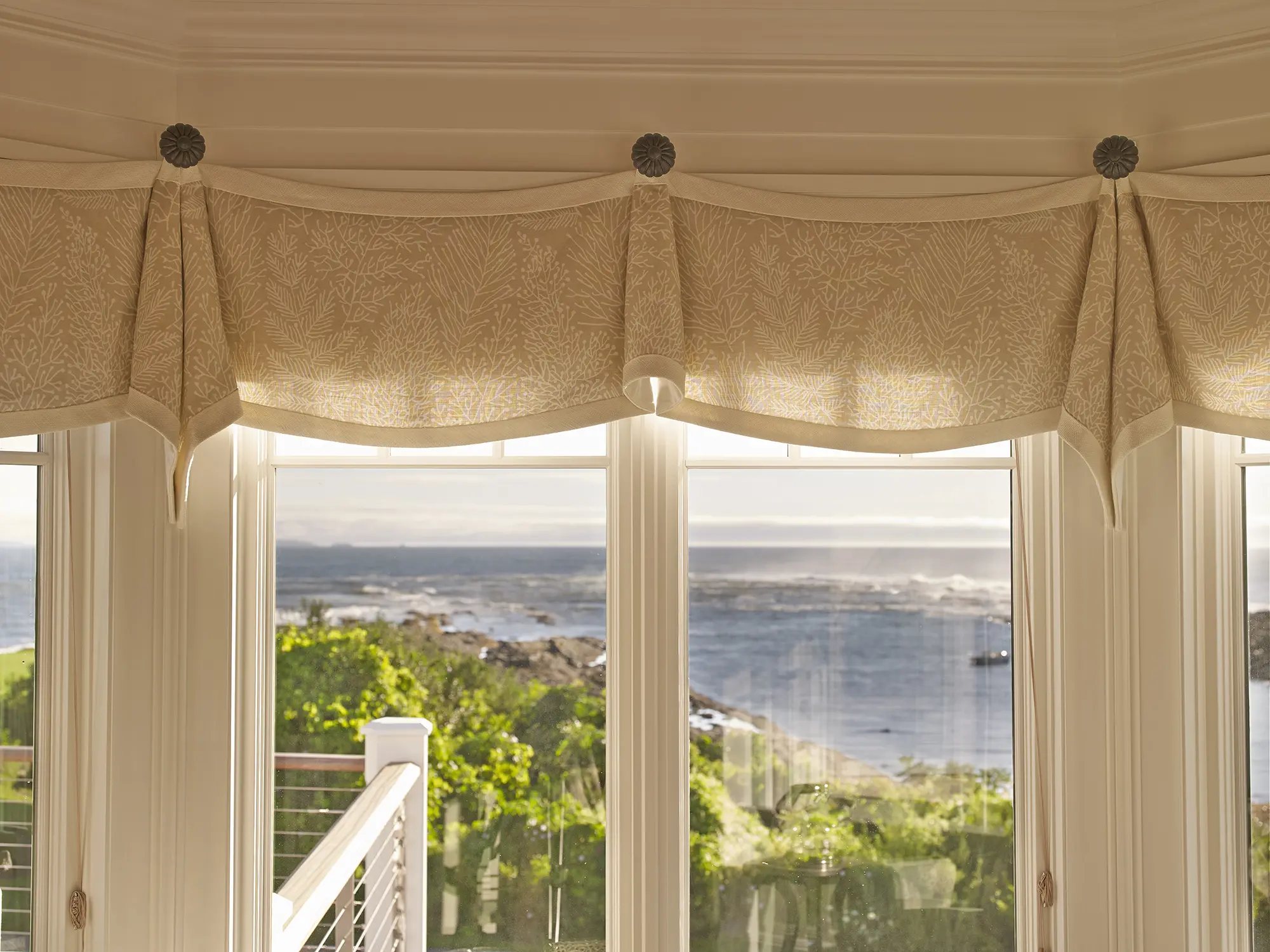 Coral draped curtains with view of ocean