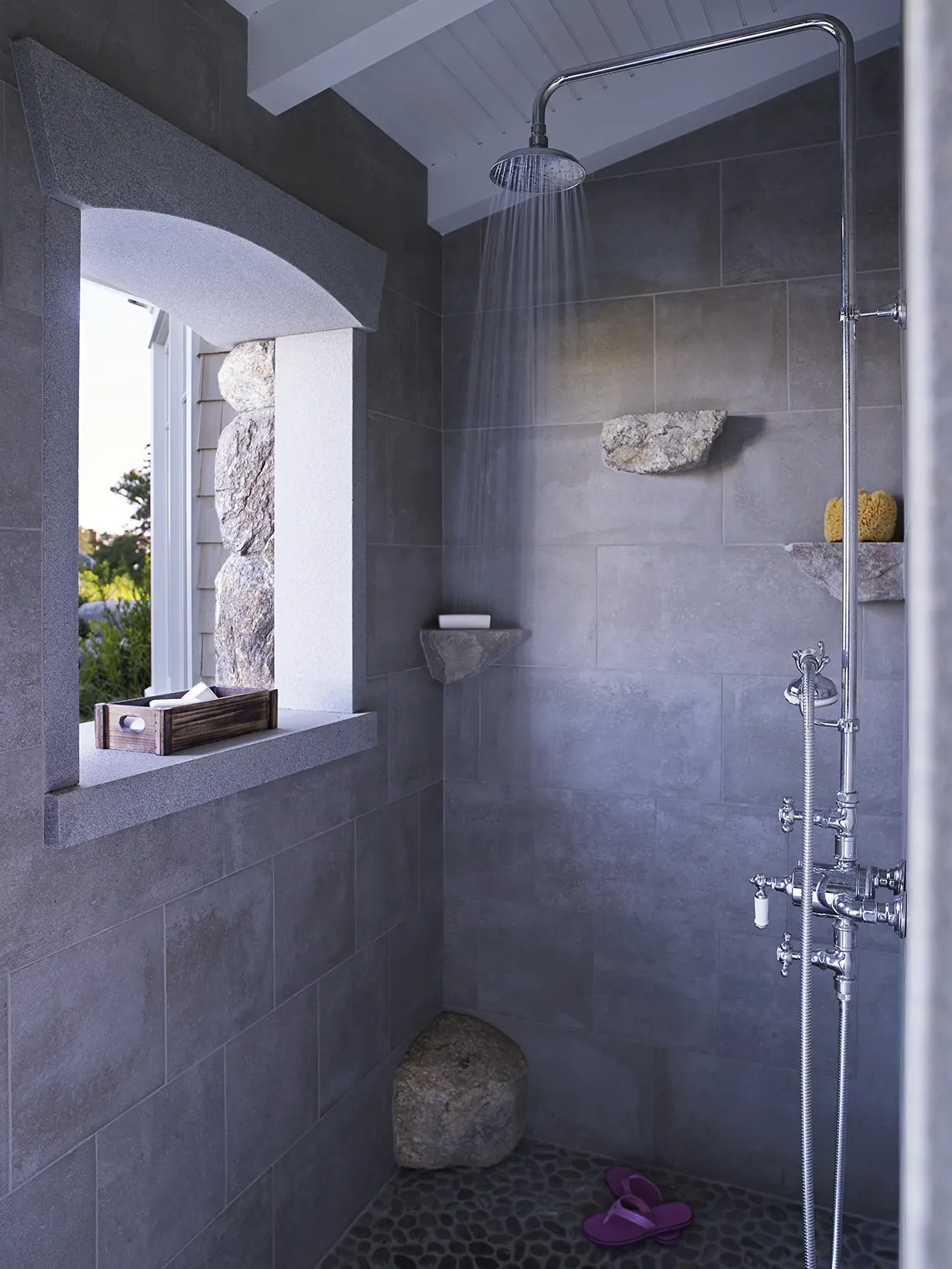 Grey tiled walk in shower with a view
