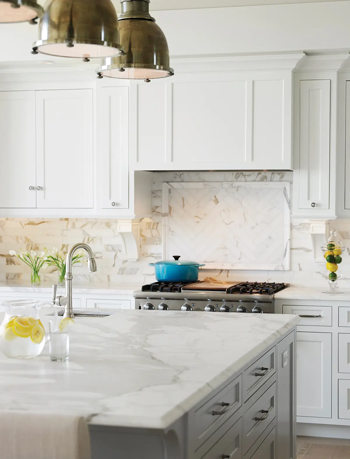 Bright white kitchen with unique marble tiled backsplash and countertop at Whales Watch