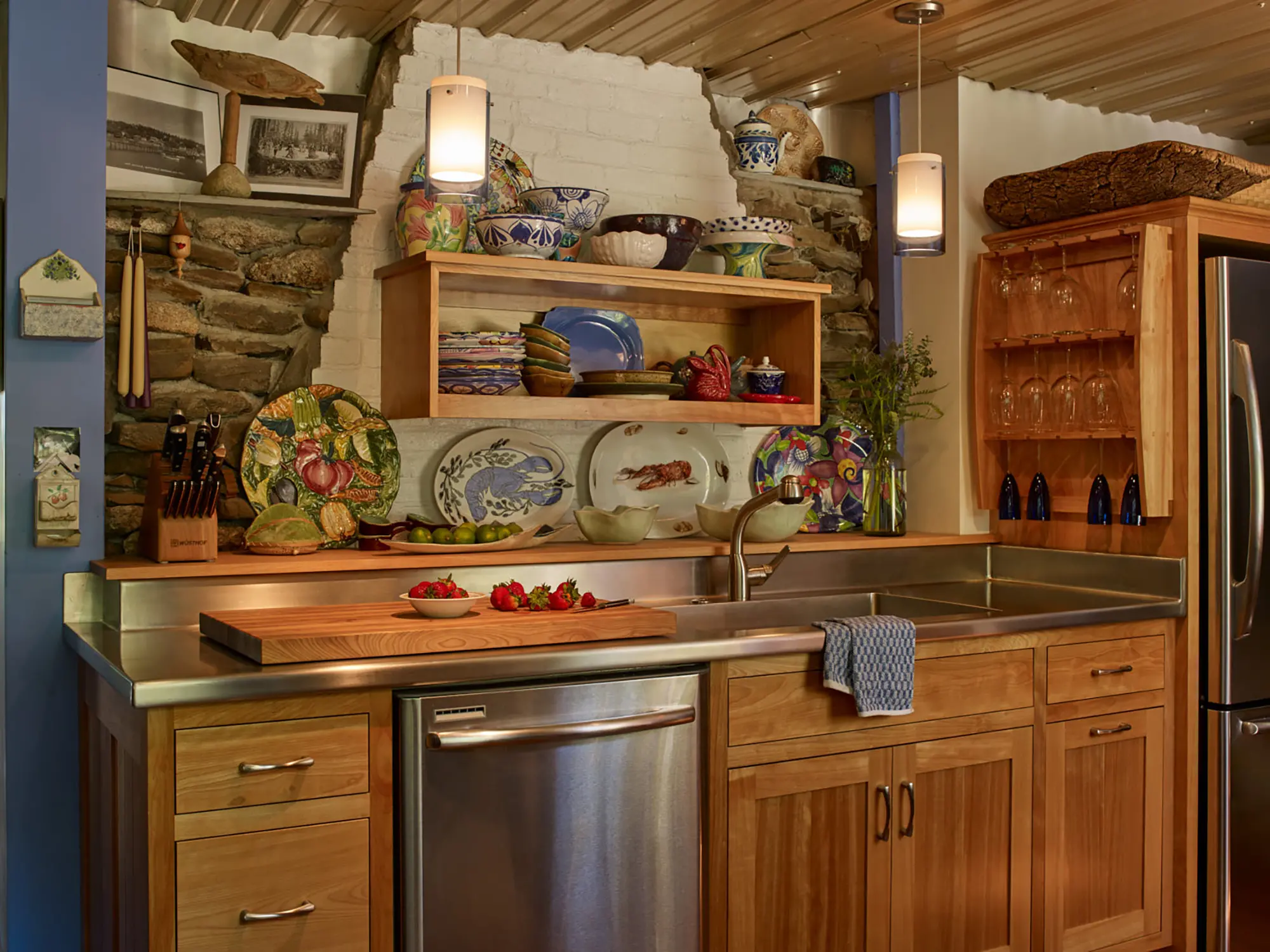 Stone, brick, wood, and stainless steel pull this kitchen together