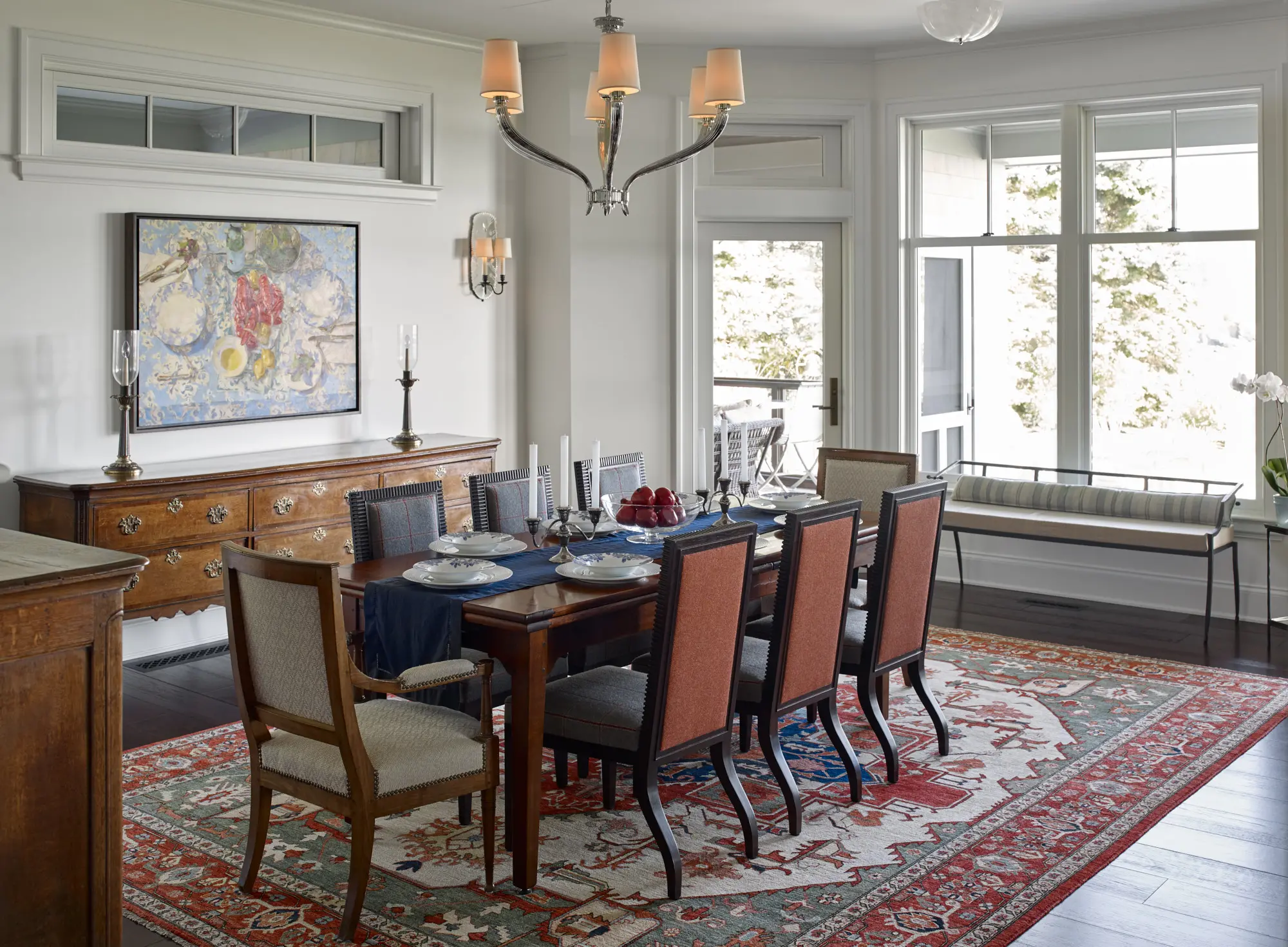 Formal dining room with natural light and red rug