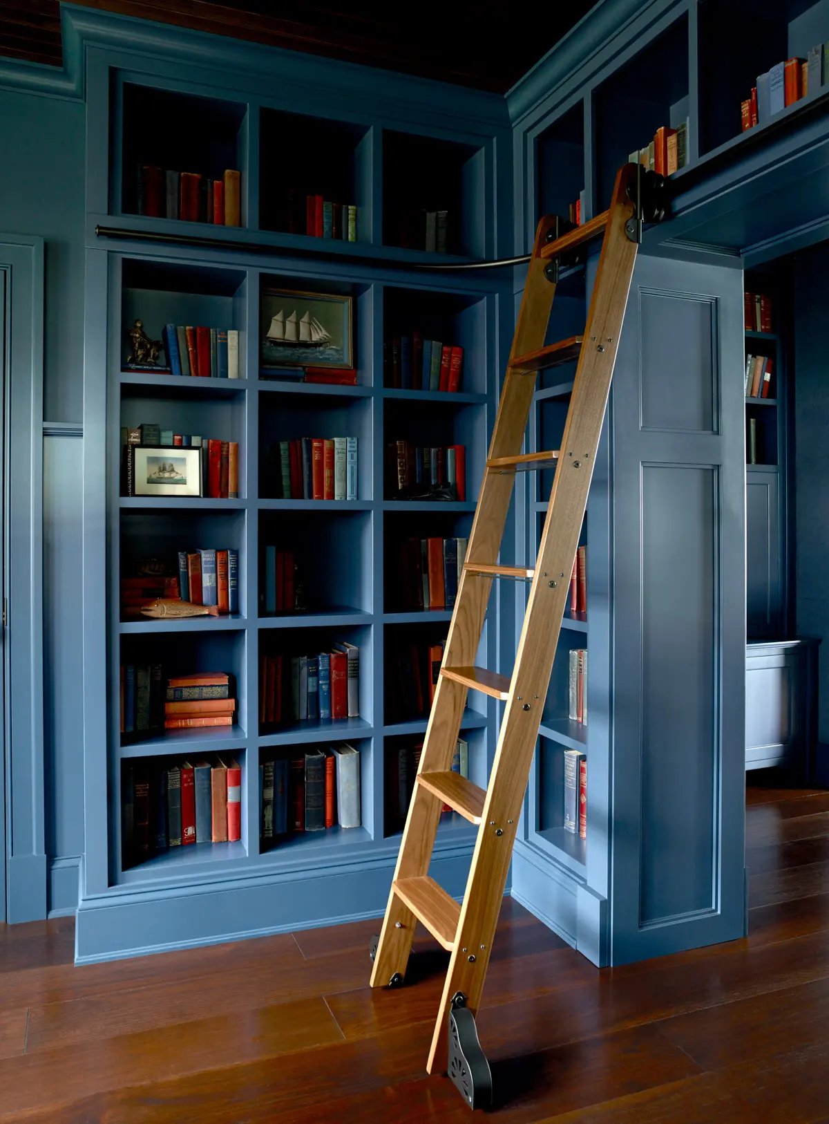 A view of the library at Pulpit Rock, complete with a ladder to reach the top shelf.