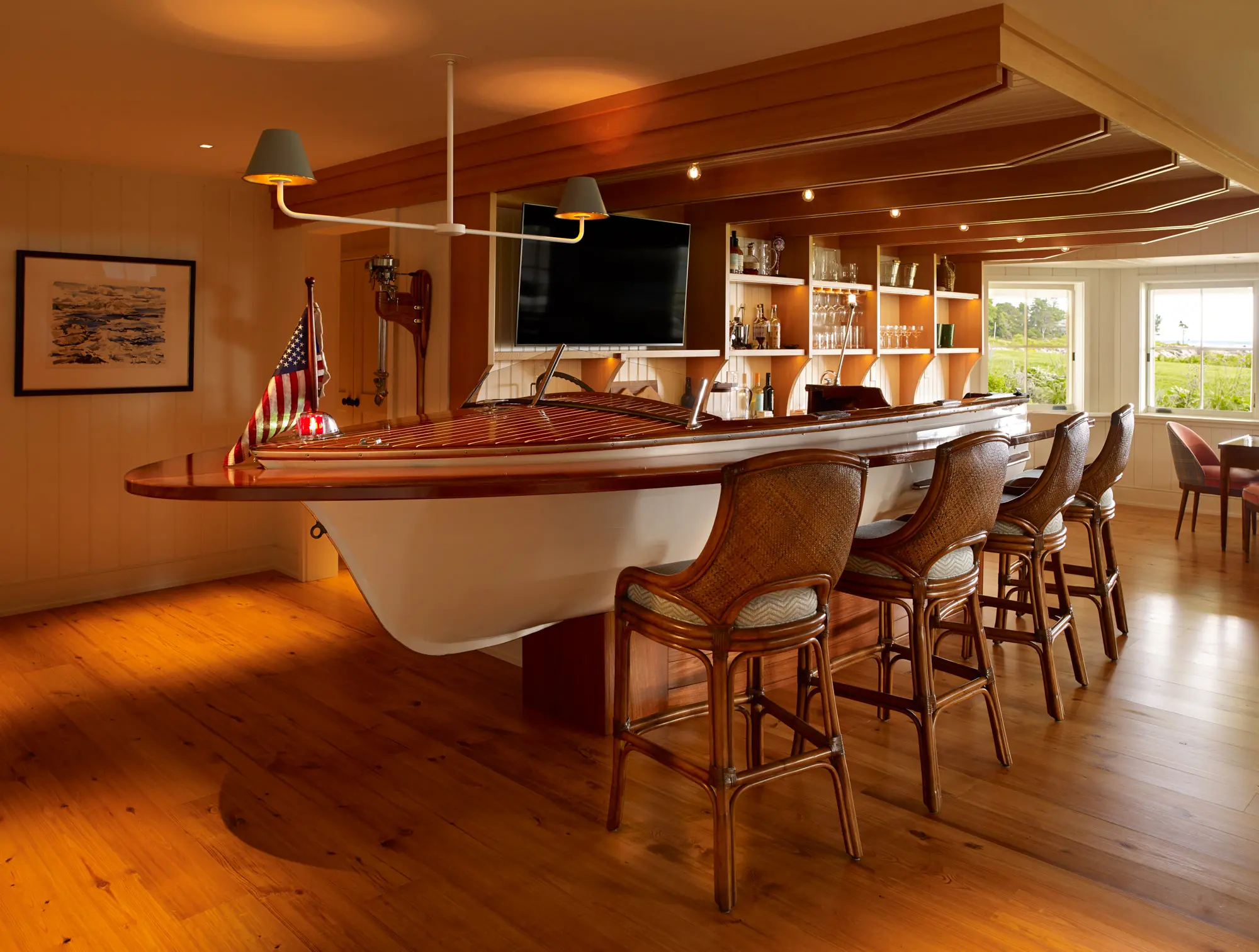 The nautical bar that features a boat as the bar and detailing on the ceiling.