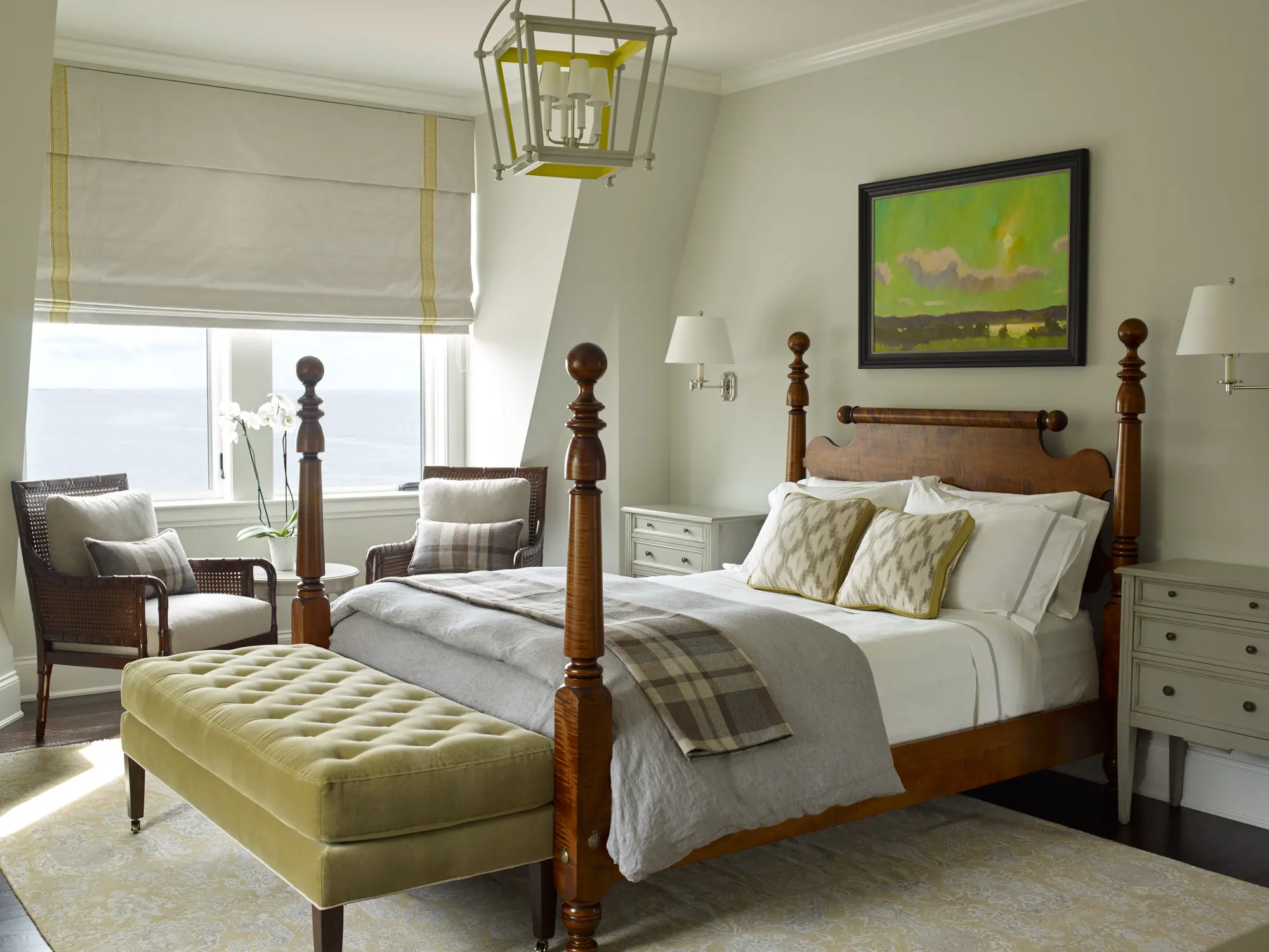 Cozy bedroom with yellow accents, sitting areas, and large windows.