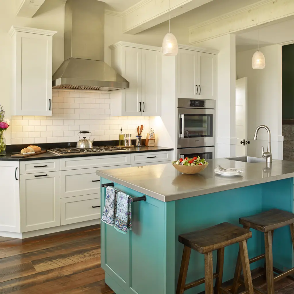 A large inviting kitchen with a beautiful blue island and hardwood floors.
