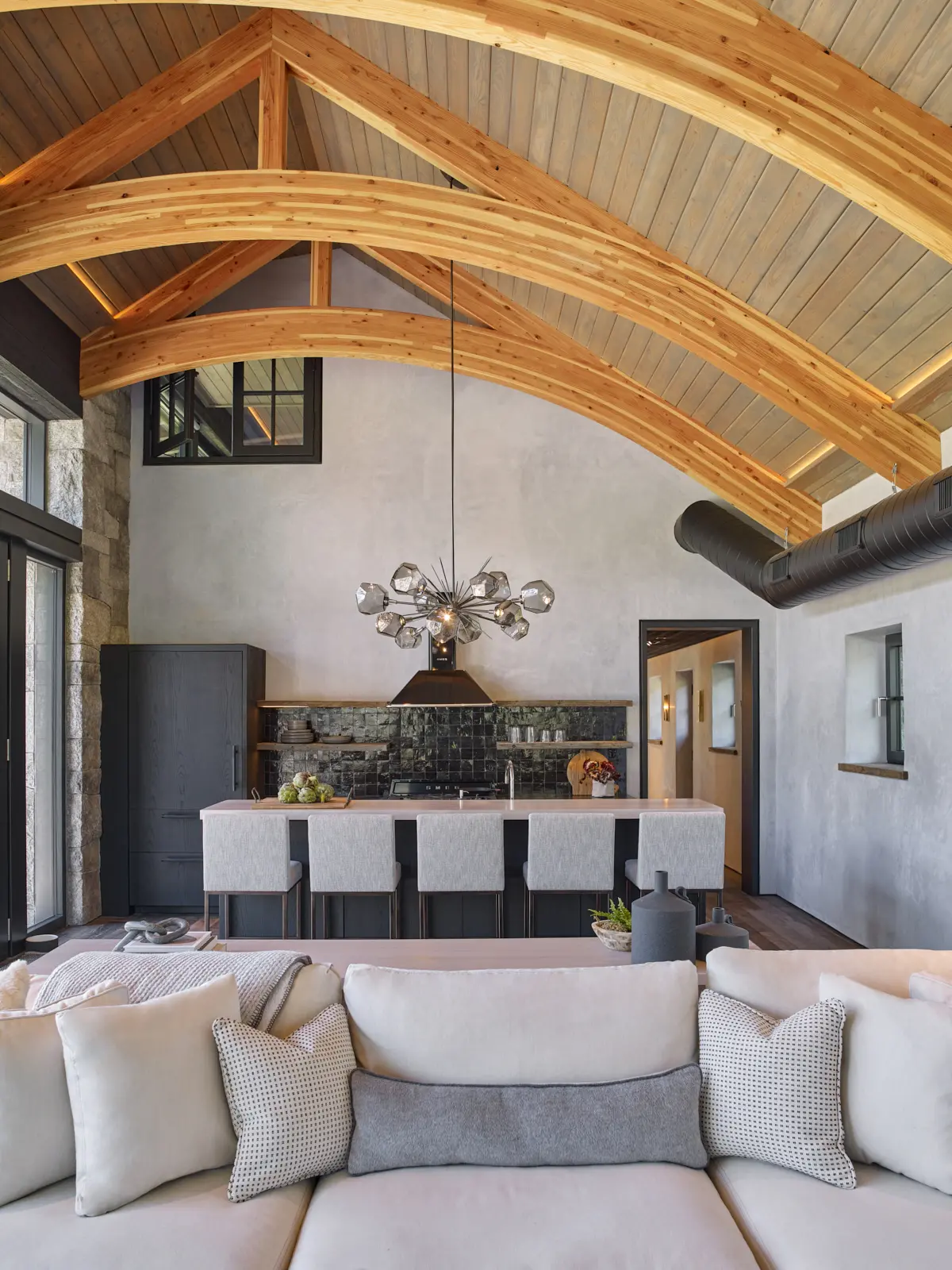 View looking back at kitchen from living area at the large arching beams overhead