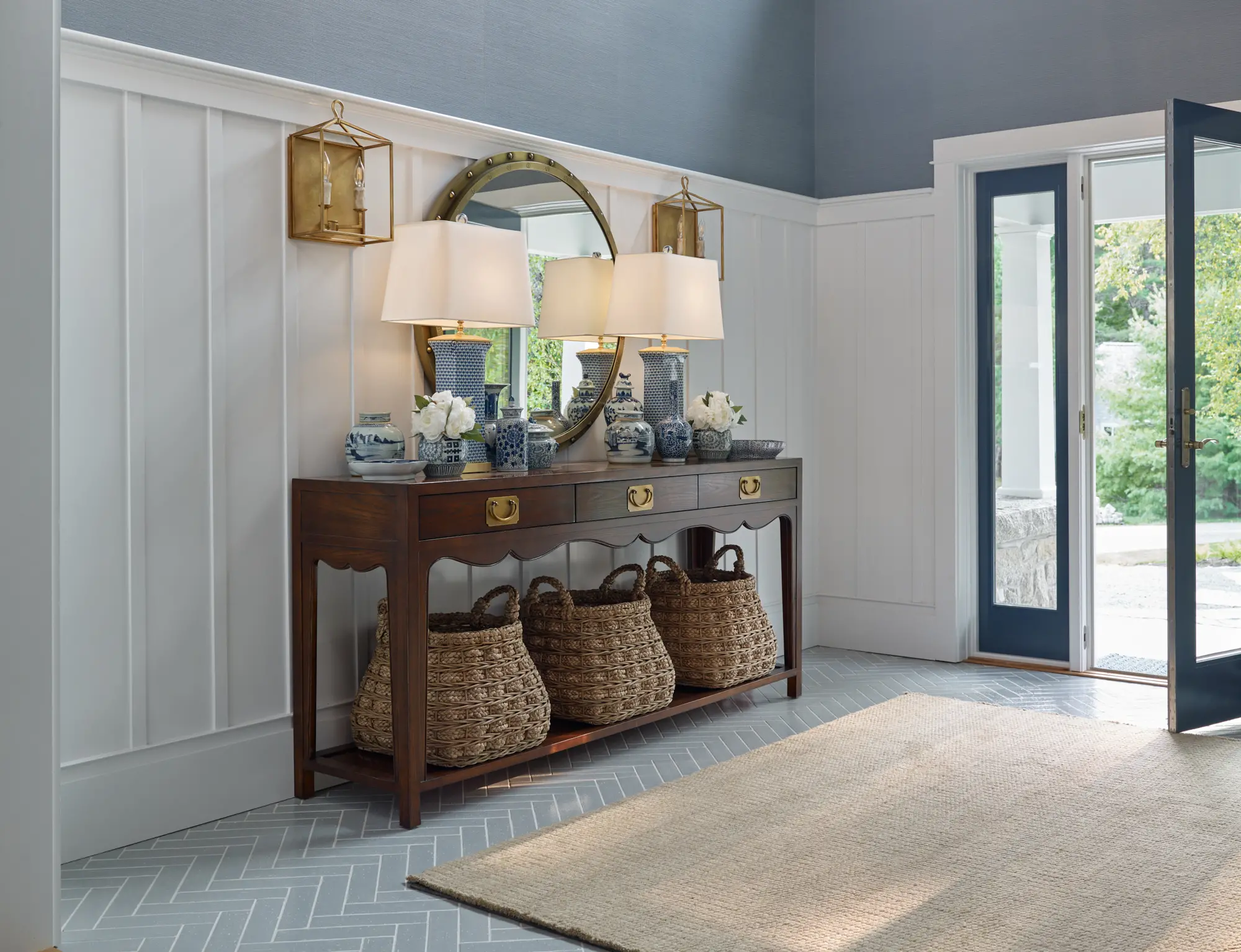 Entryway with gold, lantern scones and decorated side table