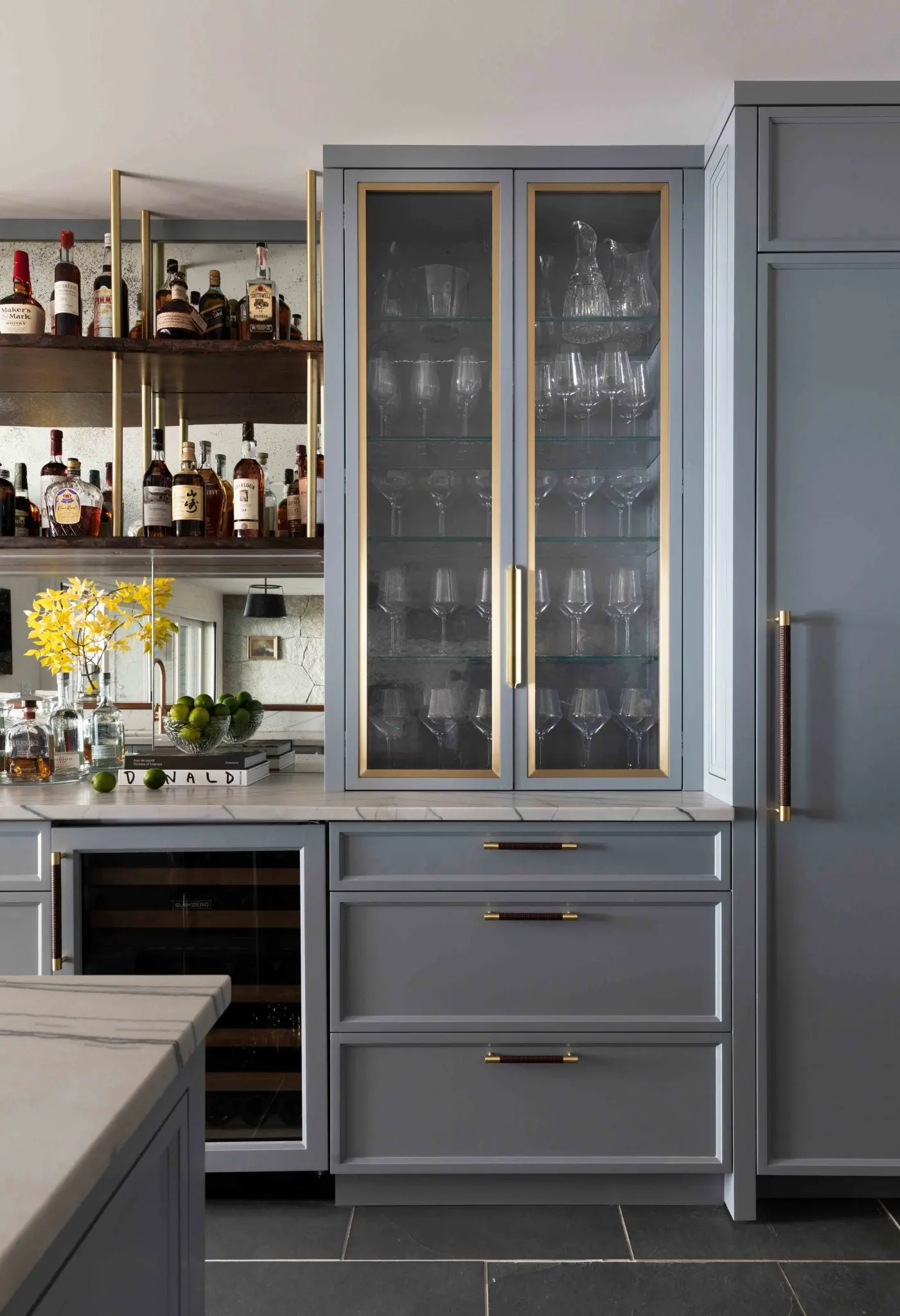 Custom cabinetry and bar with gold hardware