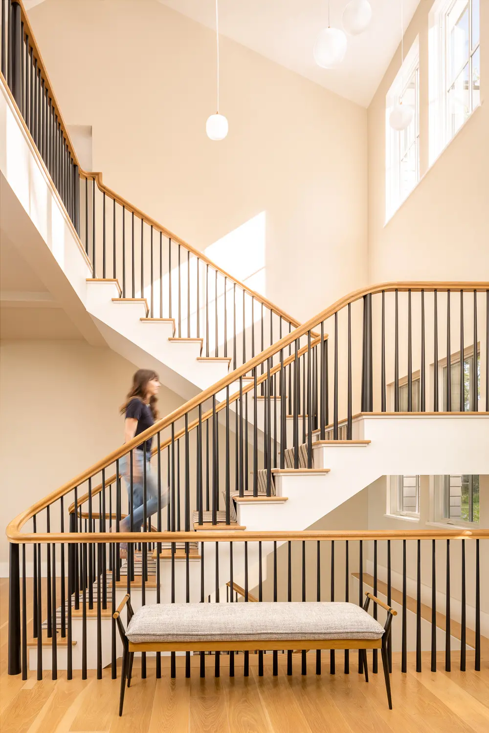 Black balusters and natural wood hand rail make for a dramatic stairway