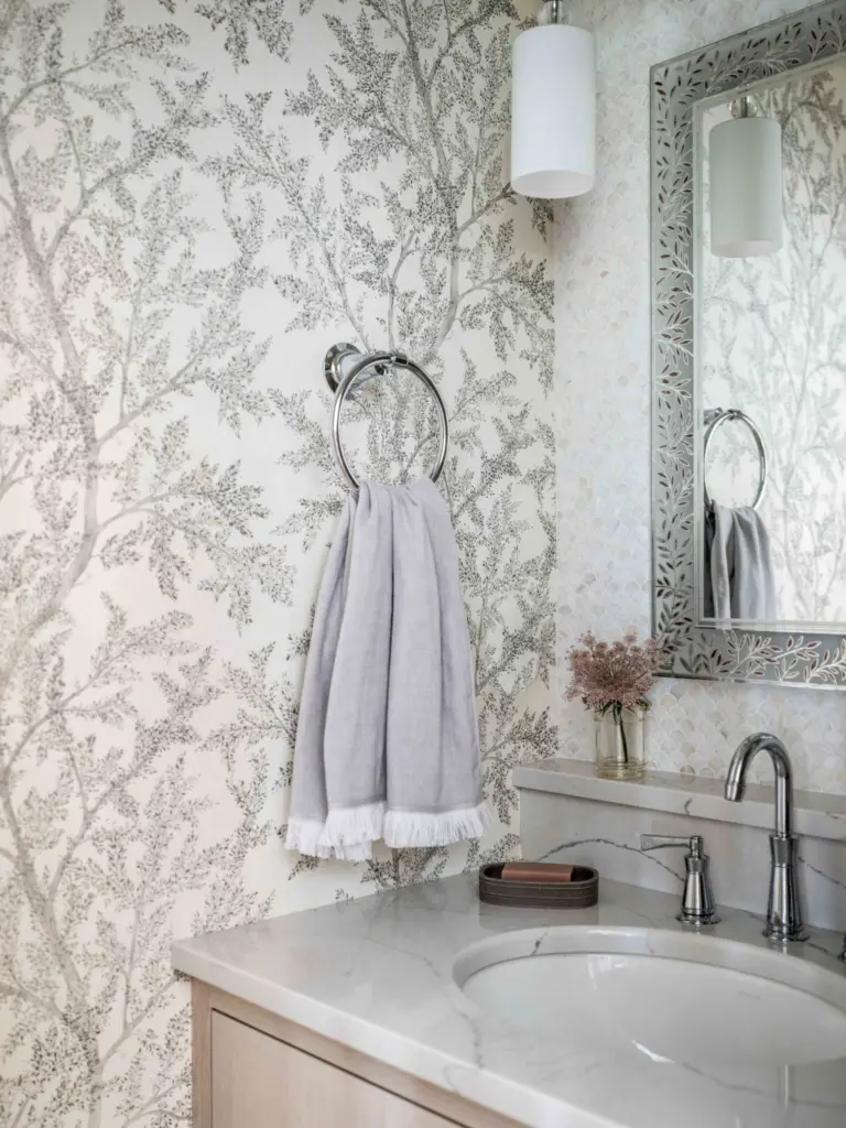 Powder room with delicate wallpaper.