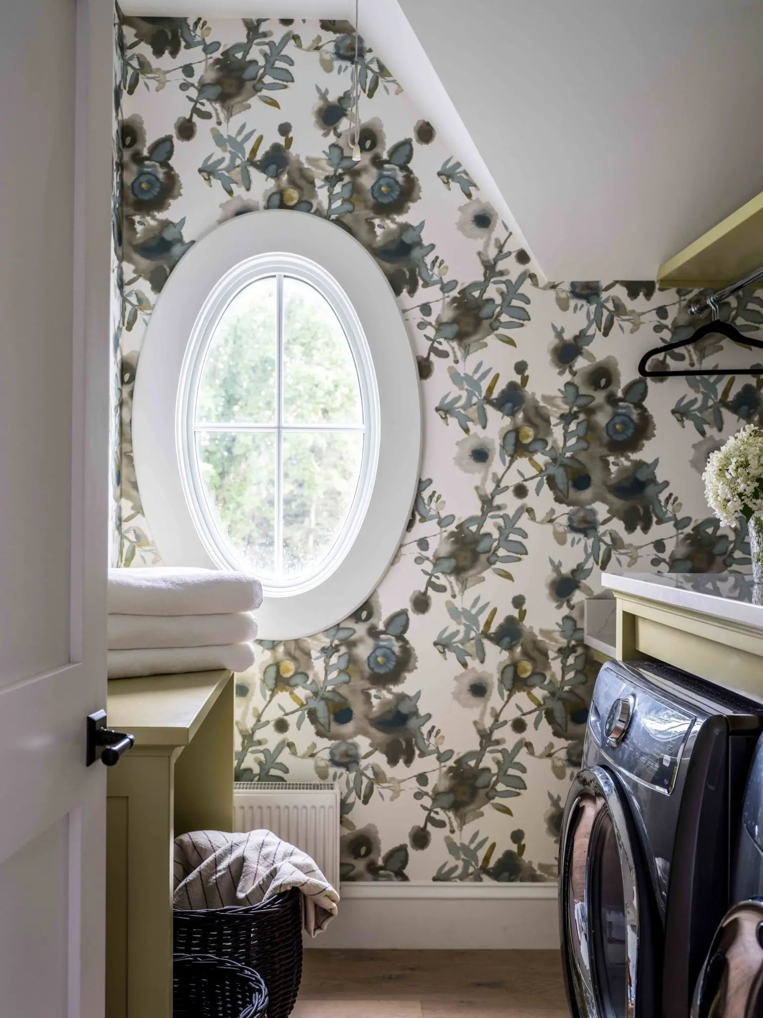 Laundry room with view through custom oval window