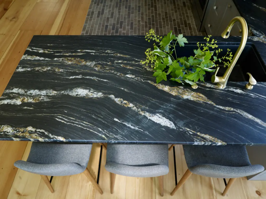 Detail of stone countertop at the peninsula featuring veining that references the rocky coast of Maine