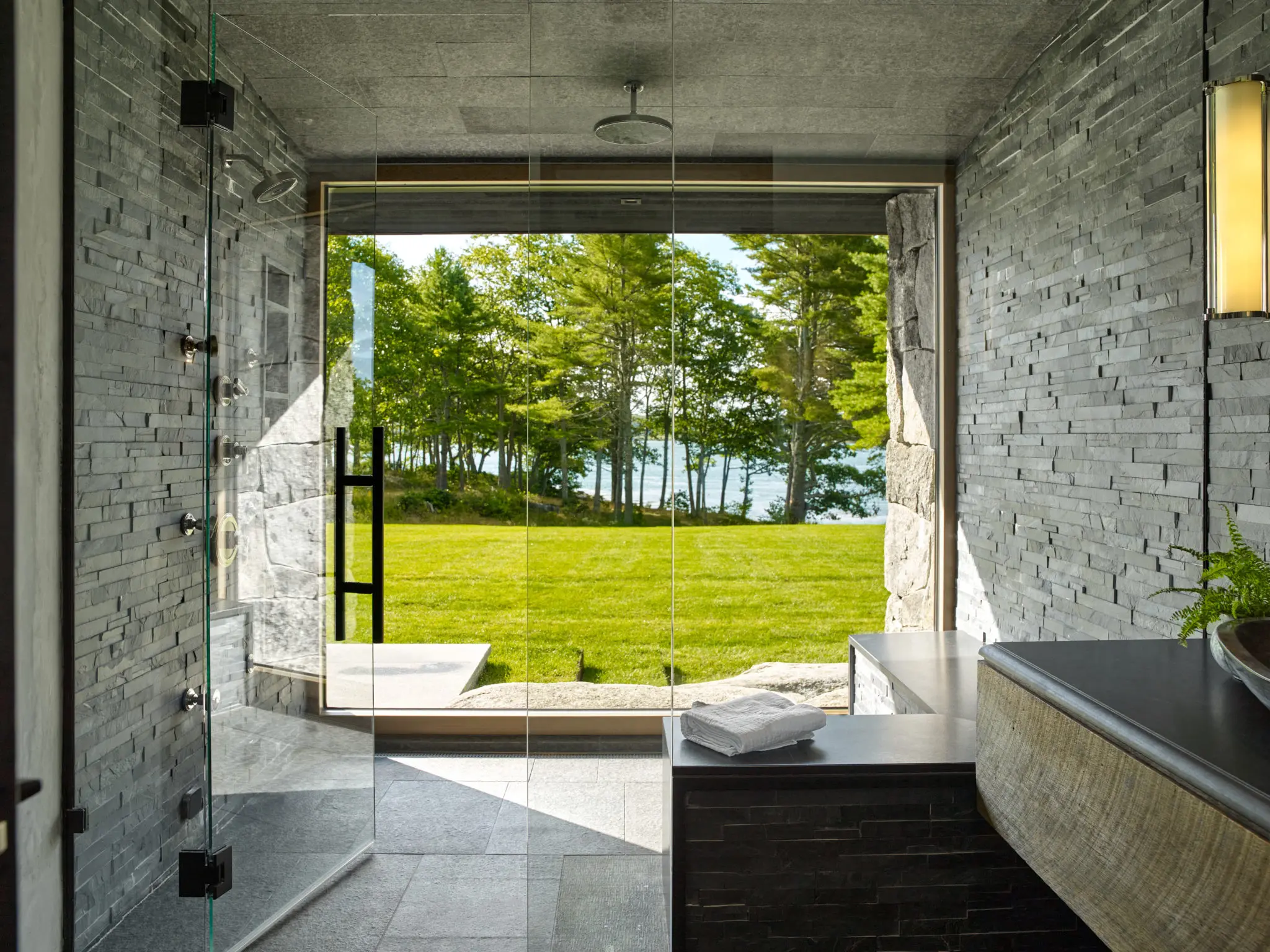 Stoneview Spa bathroom with rain forest shower head and stone tiles walls