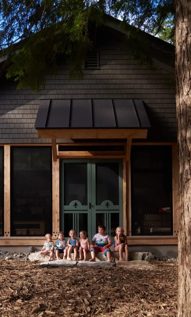 Children sitting on the stone steps of the screened in porch of Cozy Bear